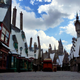 Hogsmeade village as viewed from the entrance of The Wizarding World of Harry Potter, complete with butterbeer cart and Hogwarts in the background.